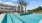 a swimming pool in front of a building