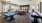 a room with a pool table and chairs