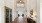 a hallway with a wood floor and a ceiling fan